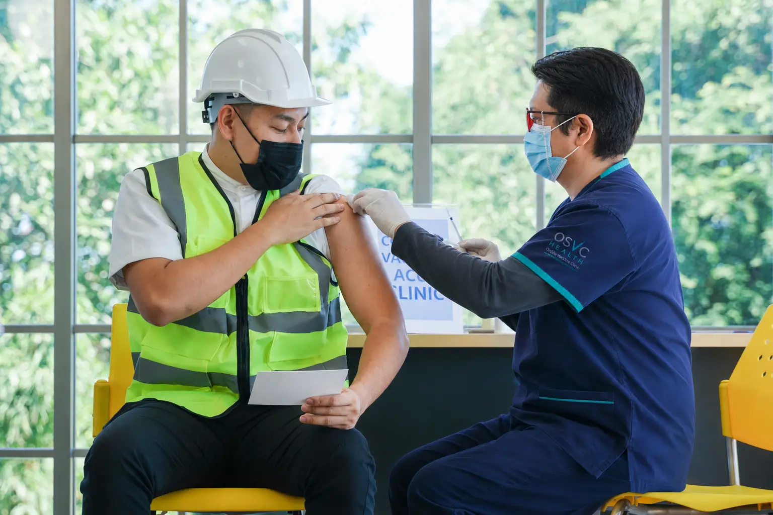 nurse giving a vaccine to person