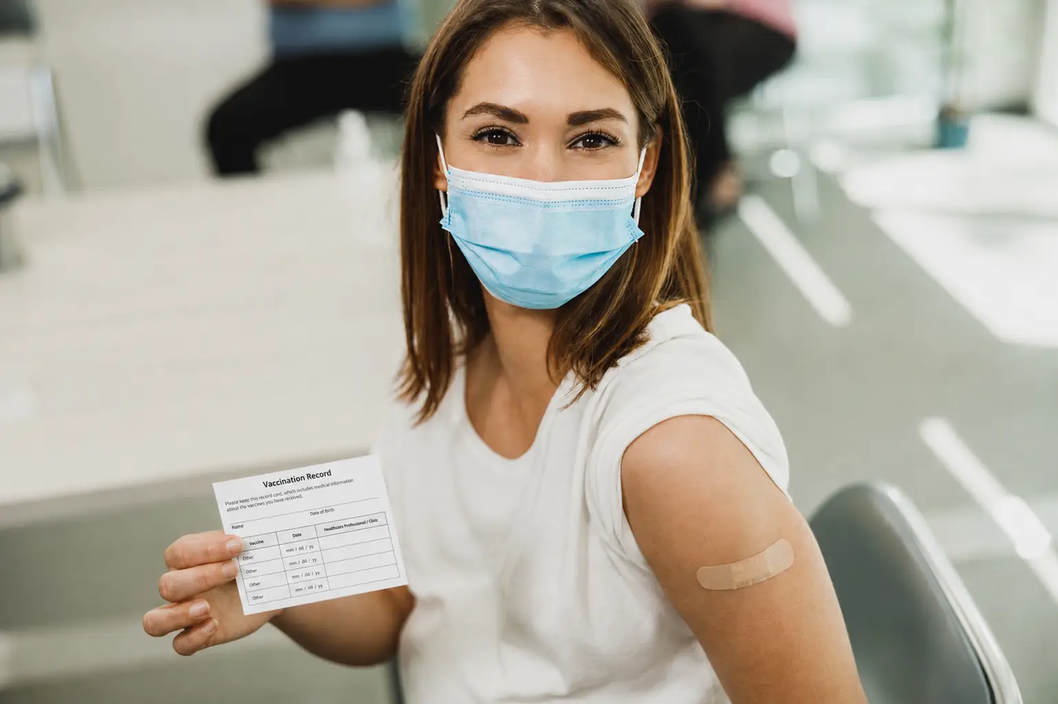 woman holding vaccine card